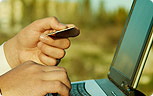 laptop with hands holding pointer